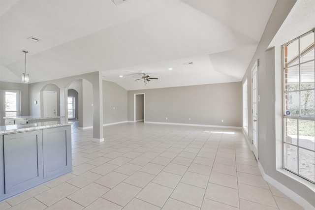 interior space with ceiling fan, light tile patterned flooring, and vaulted ceiling