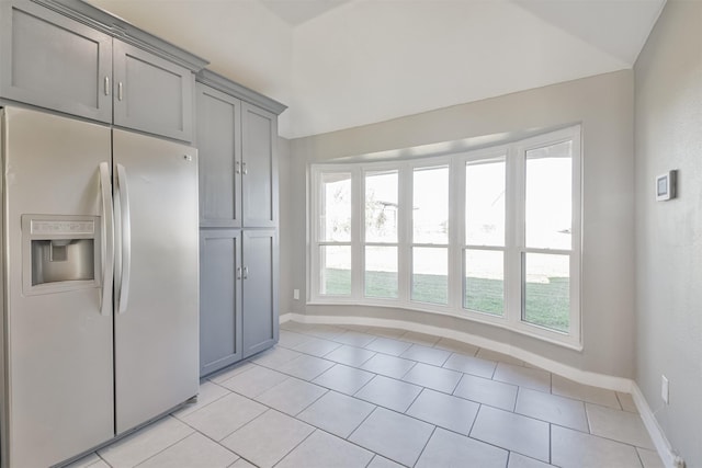 kitchen featuring gray cabinets, stainless steel fridge with ice dispenser, and plenty of natural light