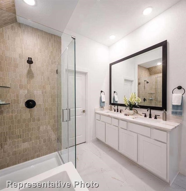 bathroom with vanity and a shower with shower door