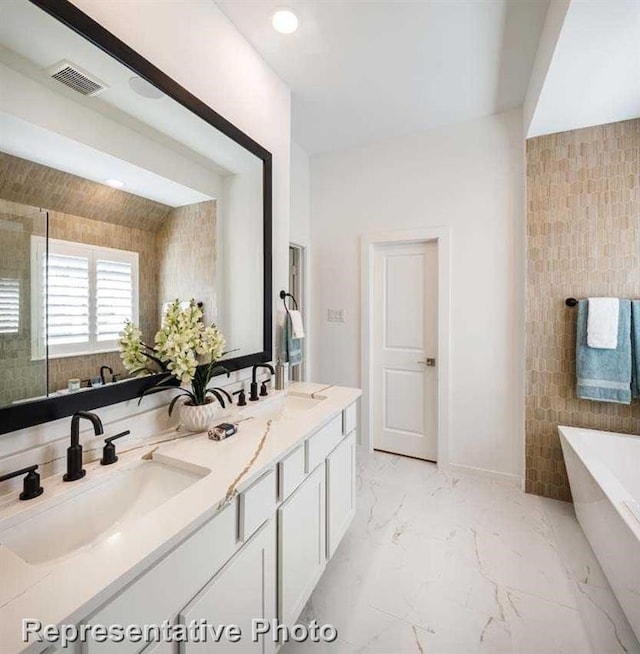 bathroom with a bathtub, tile walls, and vanity