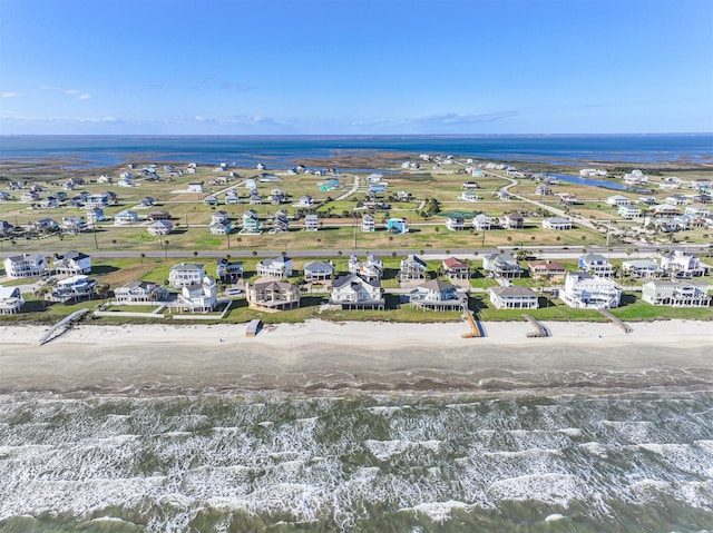 birds eye view of property featuring a water view and a view of the beach