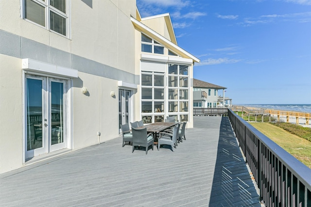 wooden terrace with french doors and a water view