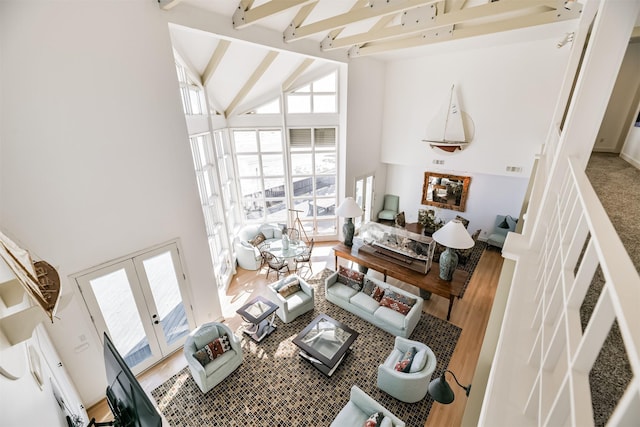 living room featuring hardwood / wood-style floors, french doors, high vaulted ceiling, and beam ceiling