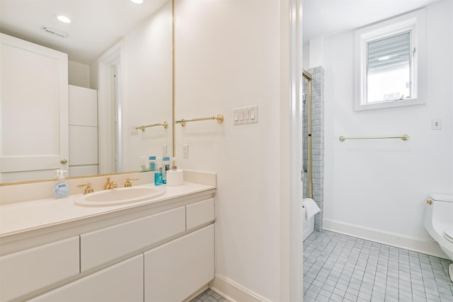 bathroom featuring tile patterned flooring, vanity, toilet, and a shower