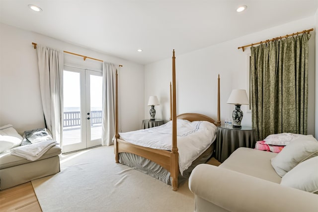 bedroom featuring access to exterior, french doors, and light wood-type flooring