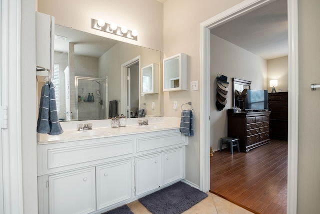 bathroom featuring tile patterned floors, vanity, a healthy amount of sunlight, and walk in shower