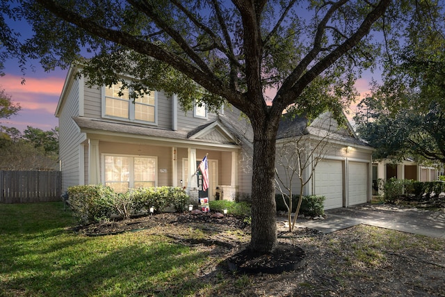 view of front of house featuring a yard and a garage