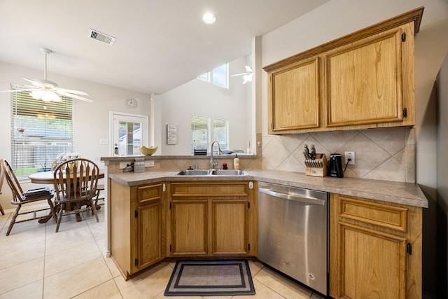 kitchen featuring ceiling fan, dishwasher, sink, decorative backsplash, and light tile patterned floors