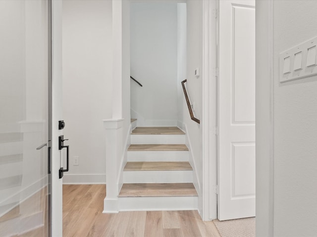 stairway featuring wood-type flooring