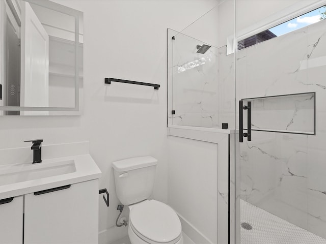 bathroom featuring an enclosed shower, vanity, and toilet