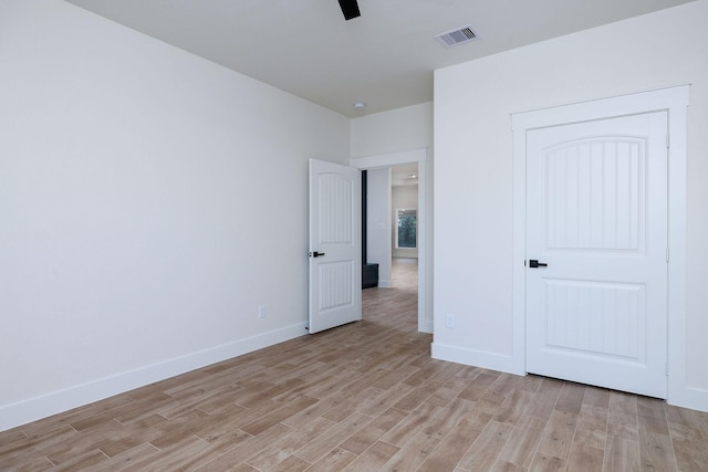 unfurnished bedroom featuring ceiling fan and light wood-type flooring