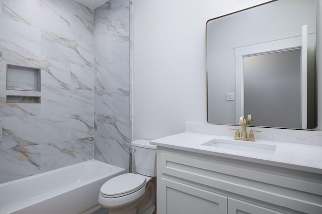 full bathroom featuring vanity, tiled shower / bath, and toilet