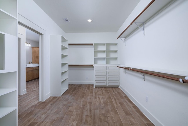 walk in closet featuring light hardwood / wood-style floors