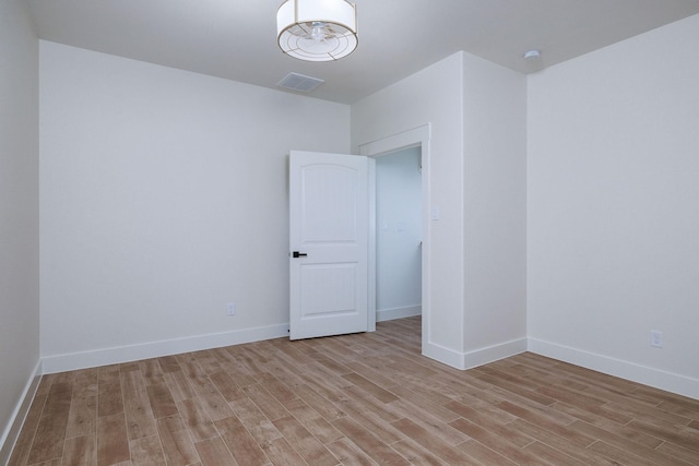 unfurnished room with light wood-type flooring