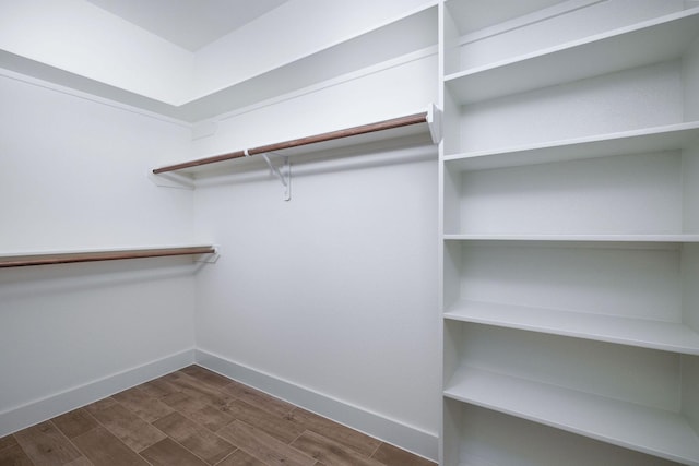 walk in closet featuring dark hardwood / wood-style flooring