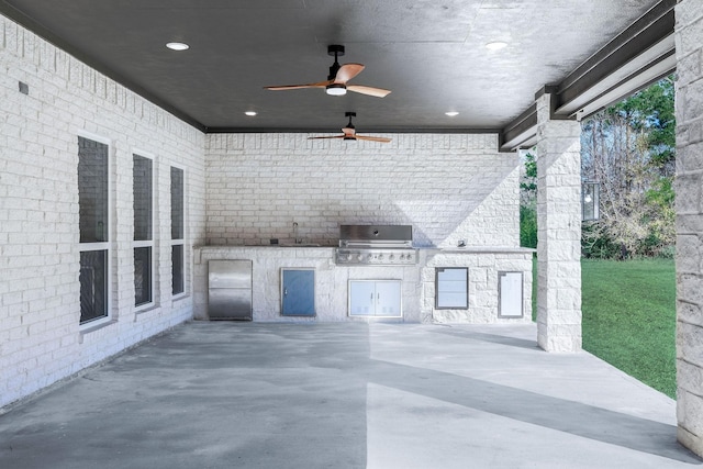 view of patio / terrace featuring ceiling fan, area for grilling, sink, and grilling area