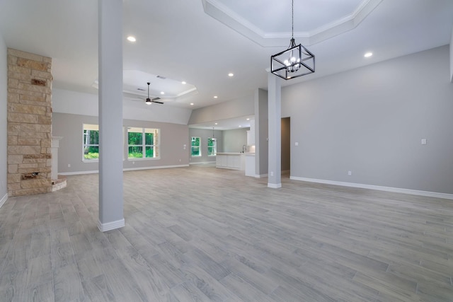 228 Feldspar Ln, Huntsville, TX 77340 - unfurnished living room with a tray ceiling, a ceiling fan, recessed lighting, light wood finished floors, and baseboards
