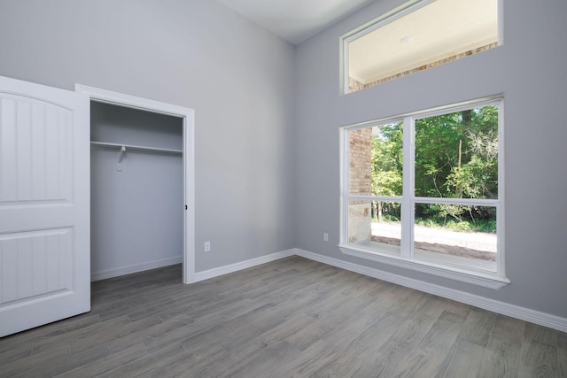 228 Feldspar Ln, Huntsville, TX 77340 - unfurnished bedroom featuring wood finished floors, baseboards, and a closet
