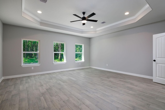 228 Feldspar Ln, Huntsville, TX 77340 - spare room with a tray ceiling, crown molding, healthy amount of natural light, a ceiling fan, and wood finished floors