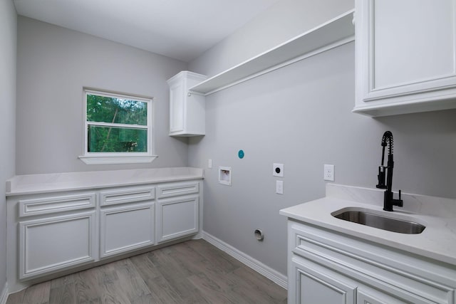 228 Feldspar Ln, Huntsville, TX 77340 - laundry room featuring hookup for a washing machine, electric dryer hookup, wood finished floors, cabinet space, and baseboards