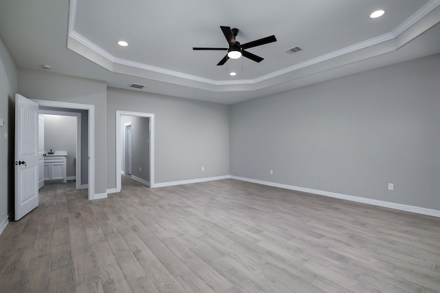 228 Feldspar Ln, Huntsville, TX 77340 - unfurnished bedroom with a tray ceiling, ornamental molding, light wood-style floors, baseboards, and recessed lighting