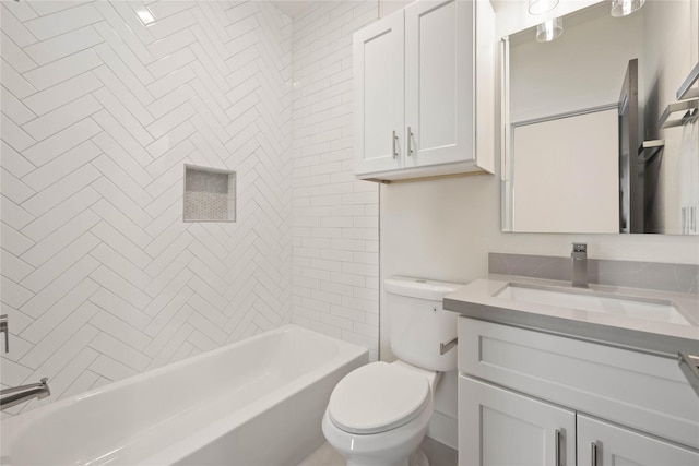 full bathroom featuring vanity, toilet, and tiled shower / bath