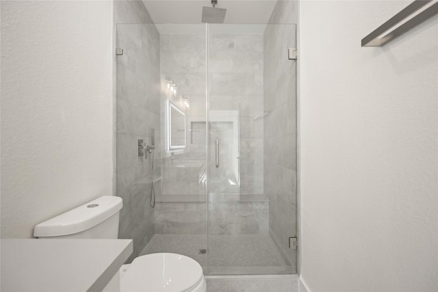 bathroom with toilet and walk in shower