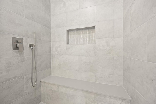 bathroom with tiled shower