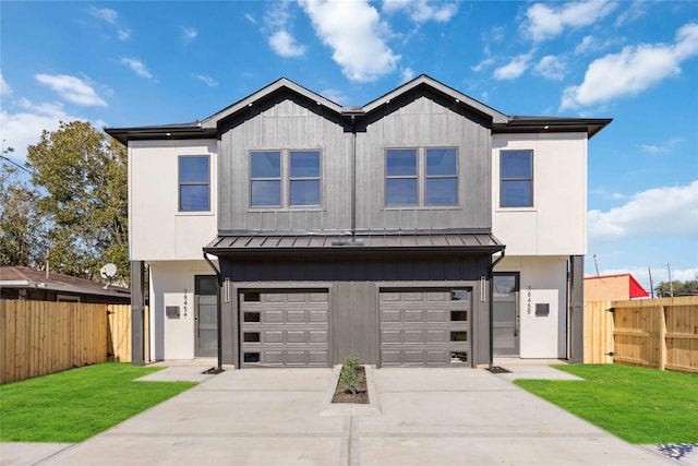 view of front of property featuring a garage and a front lawn