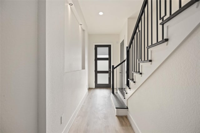 hall with light hardwood / wood-style flooring