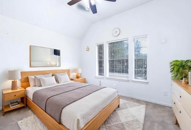 bedroom featuring ceiling fan, light carpet, and vaulted ceiling