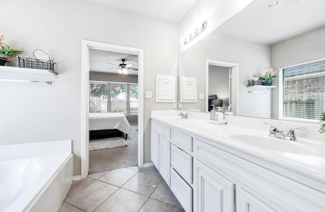 bathroom with tile patterned flooring, vanity, ceiling fan, and a washtub