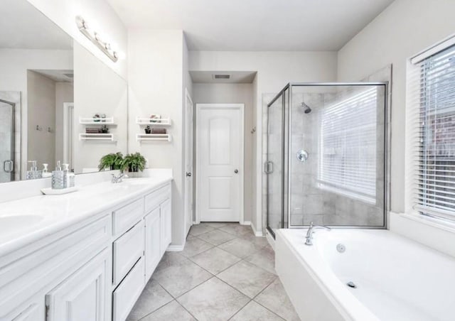 bathroom featuring tile patterned floors, vanity, and a shower with shower door