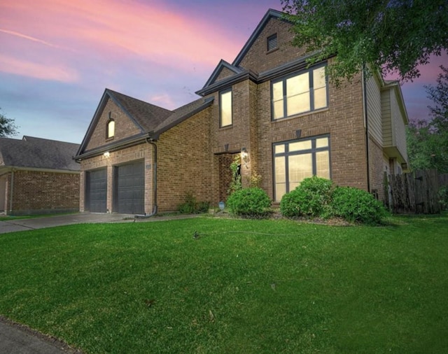 view of front of home with a yard and a garage