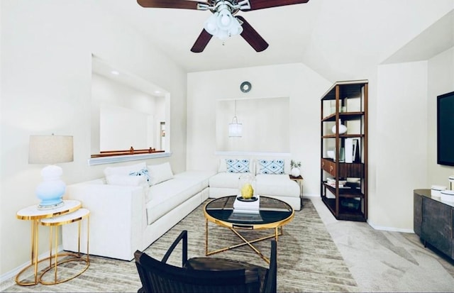 carpeted living room featuring vaulted ceiling and ceiling fan