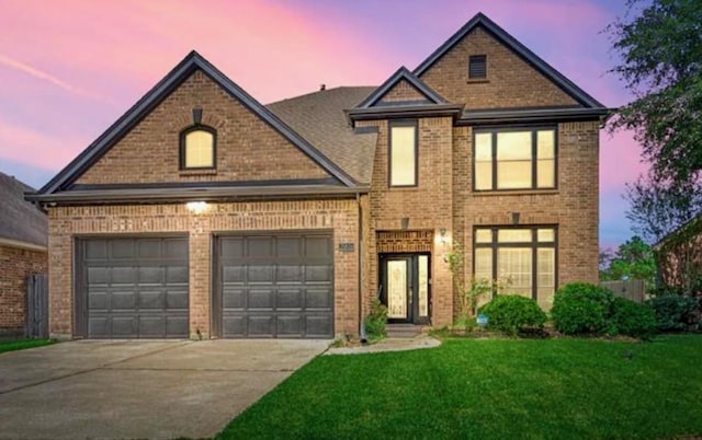 view of front of home with a yard and a garage