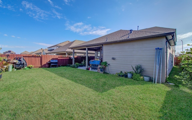 rear view of property featuring a lawn