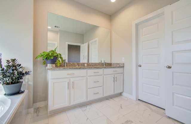 bathroom featuring vanity and a bathtub