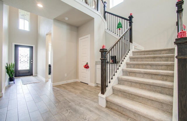 entryway featuring a high ceiling and hardwood / wood-style floors