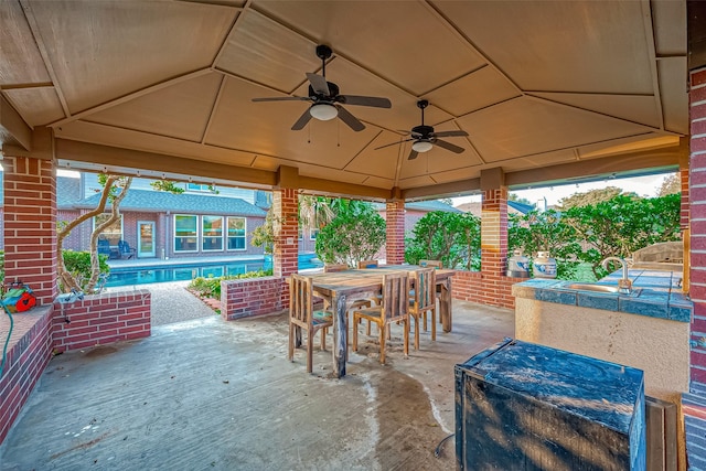 view of patio featuring ceiling fan and sink