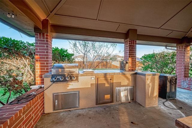 view of patio with area for grilling and exterior kitchen