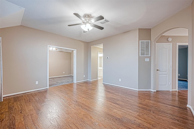 spare room featuring hardwood / wood-style floors, vaulted ceiling, and ceiling fan