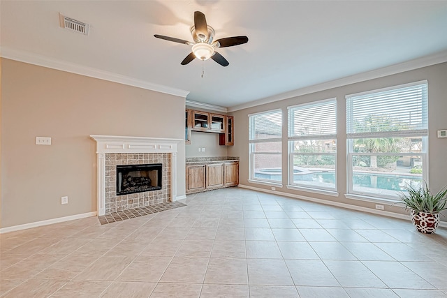 unfurnished living room with a wealth of natural light, crown molding, and ceiling fan