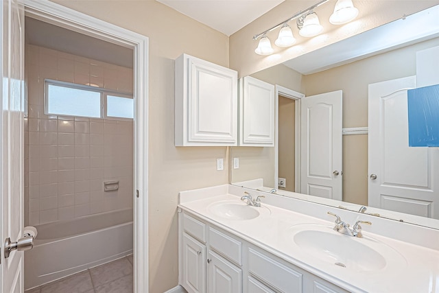 bathroom featuring tile patterned flooring, vanity, and tiled shower / bath combo