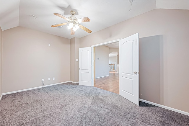 unfurnished bedroom featuring ceiling fan, carpet floors, and vaulted ceiling