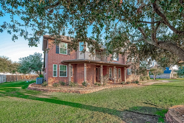 view of front of property with central AC unit and a front lawn