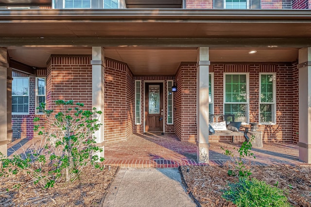 view of exterior entry with covered porch