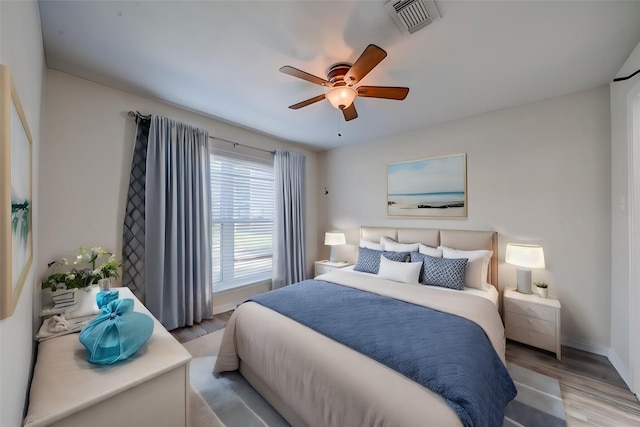 bedroom with light hardwood / wood-style floors and ceiling fan