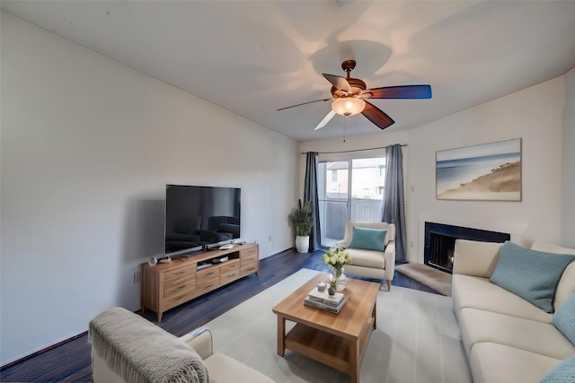 living room with dark hardwood / wood-style floors and ceiling fan