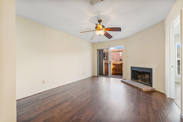 unfurnished living room featuring ceiling fan and dark hardwood / wood-style floors